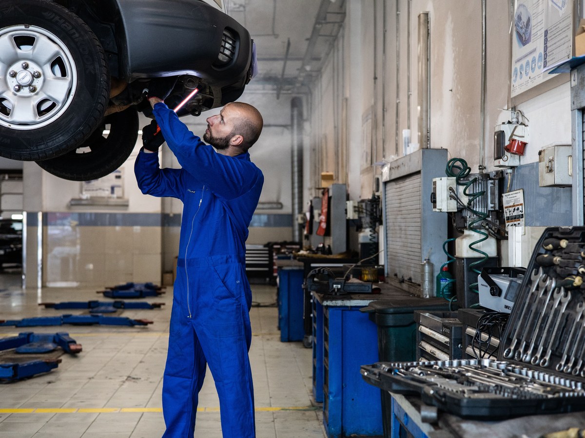 Mechanic working under a car on a lift