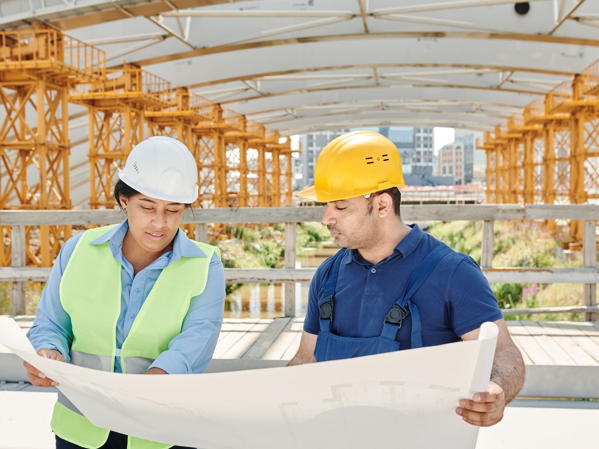 Two site staff reviewing drawings on a development