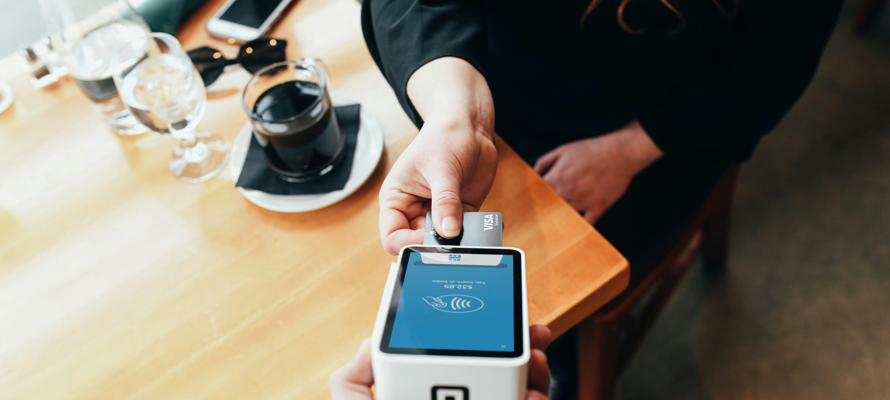 Contactless card payment at a cafe table