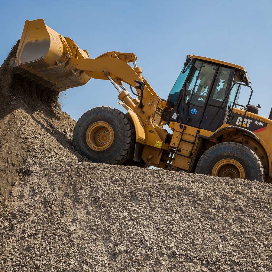 Loading shovel tipping aggregate on a site