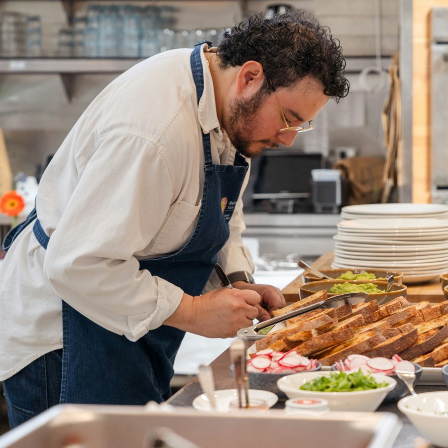 Chef preparing plates in a commercial kitchen