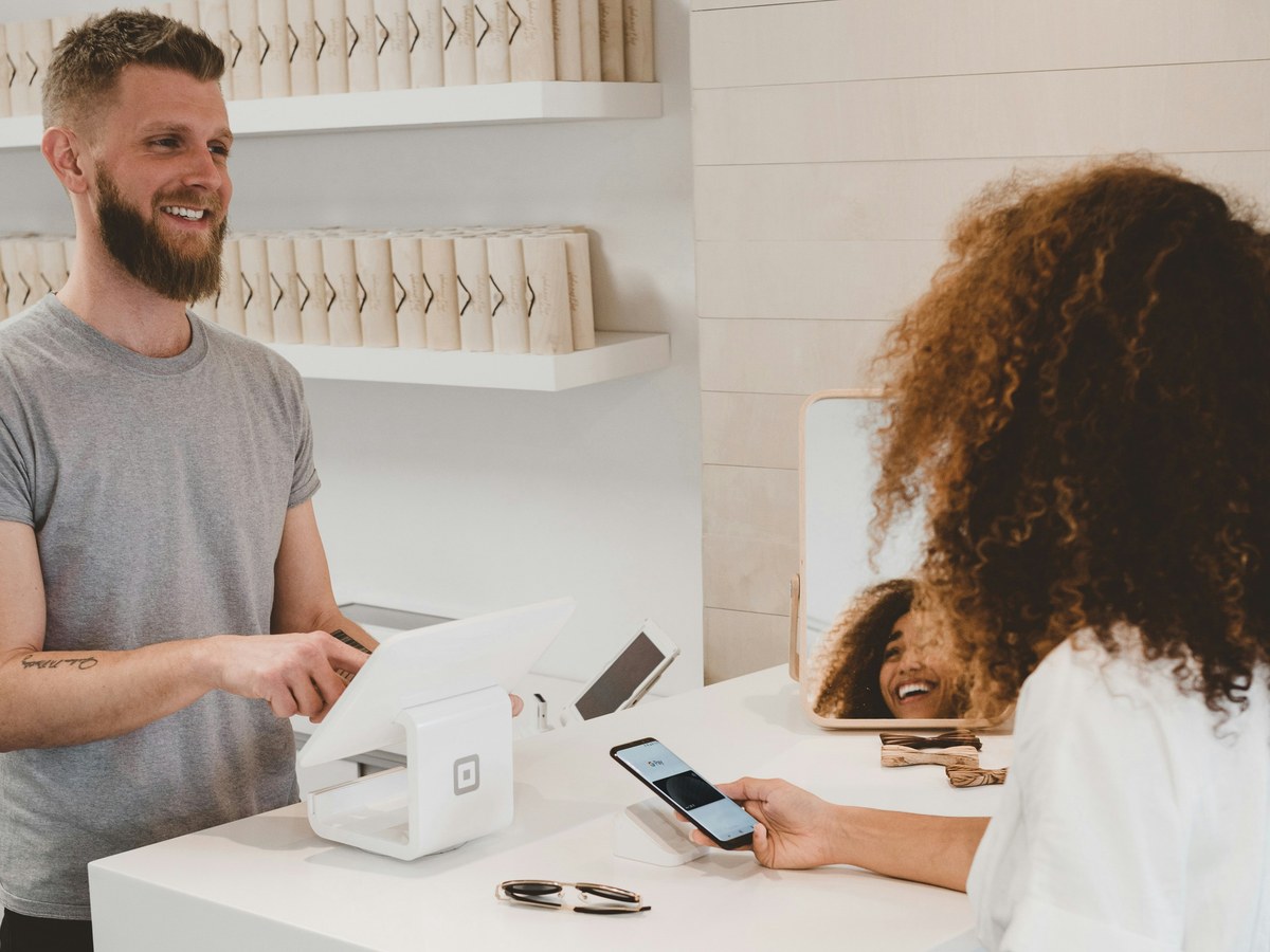 Shopkeeper serving a customer at the counter