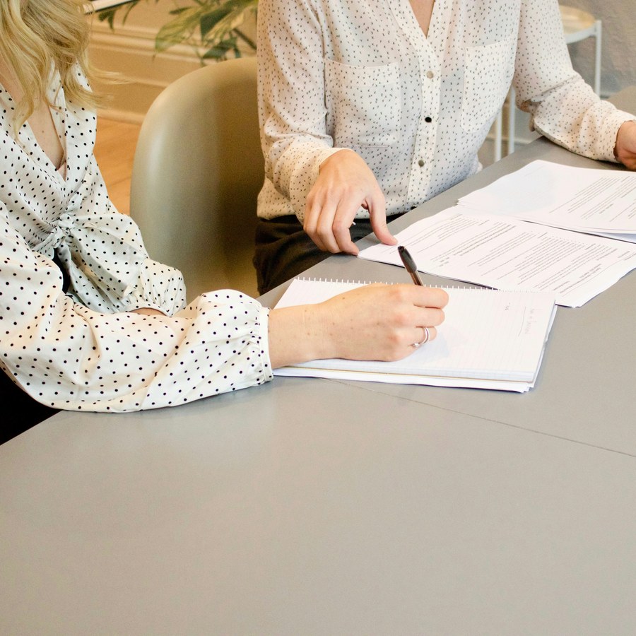 Two colleagues going through documents at a table