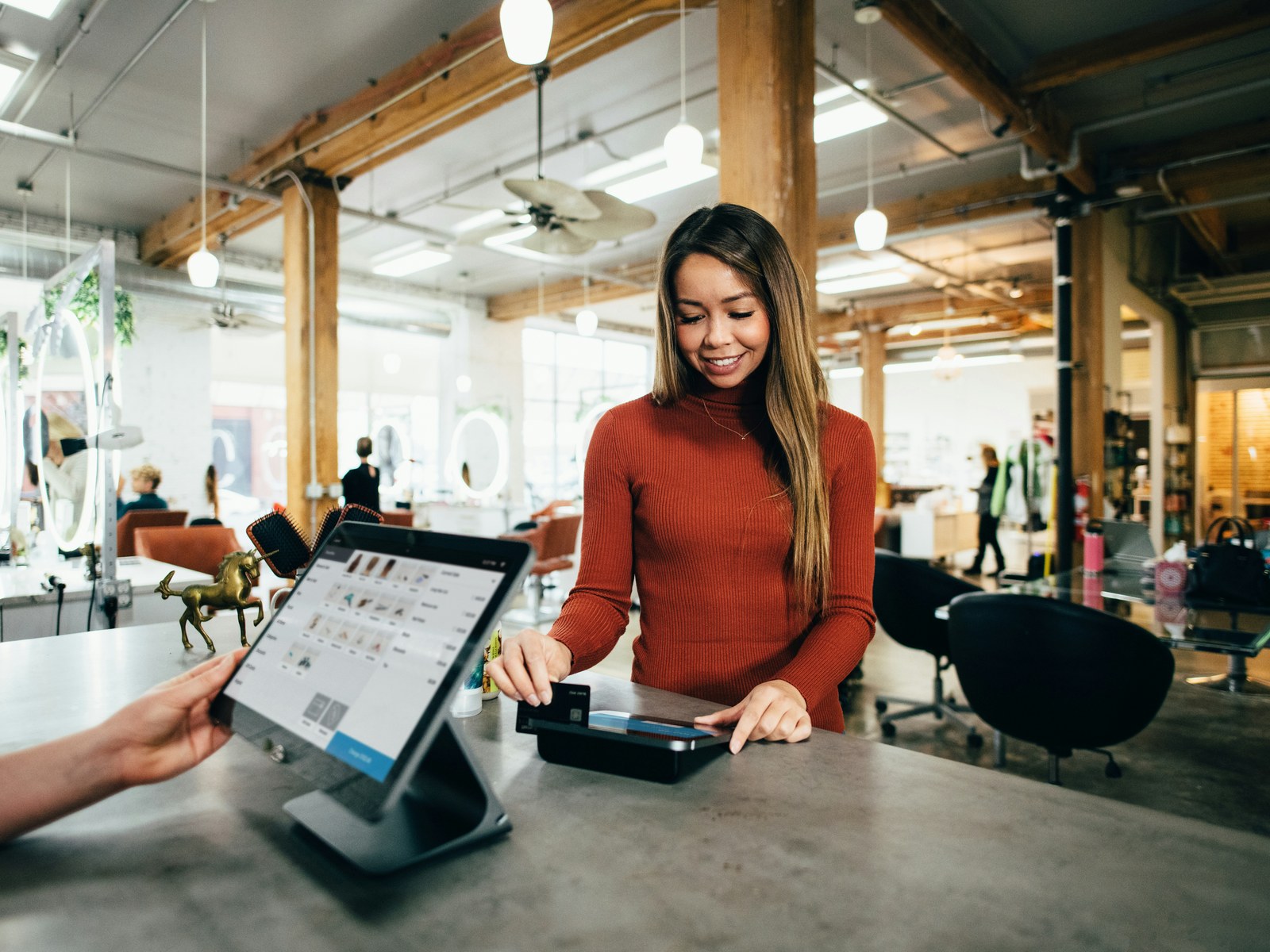 Customer paying by card at a shop counter